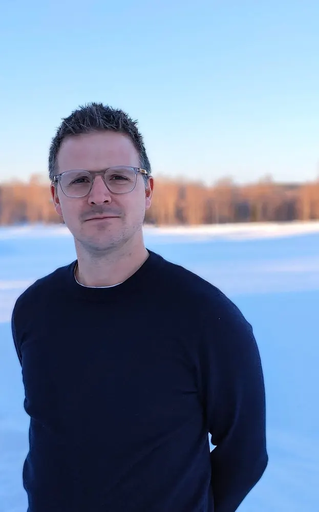 Jonny Cooper, founder of Off the Map Travel, on a frozen lake in Swedish Lapland